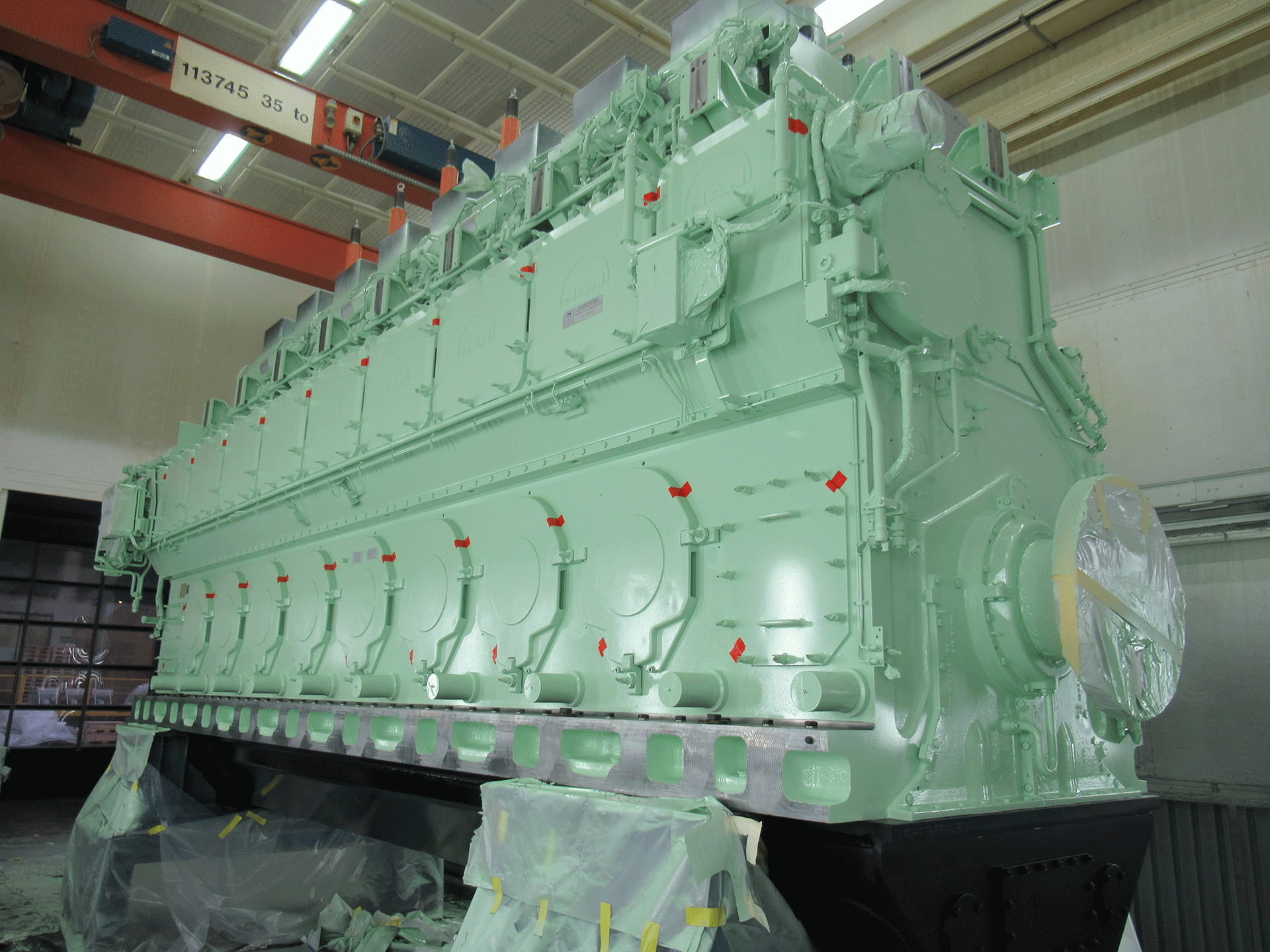 Ship diesel engine 8L48/60CR after painting. Engine is still partially masked.